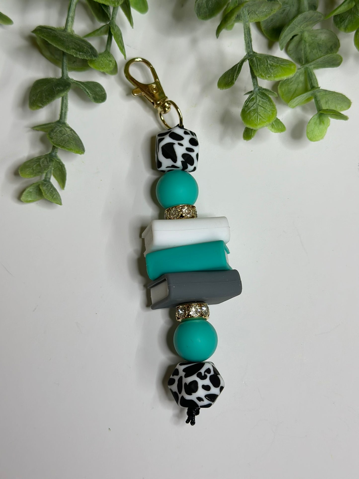 Turquoise Cow Print Book Keychain